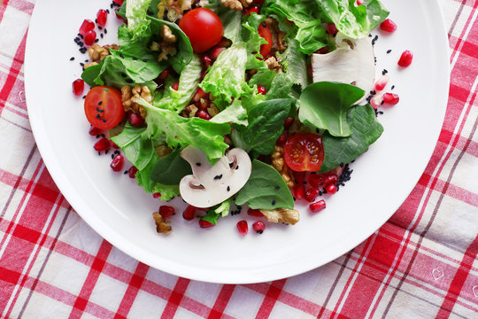 Fresh salad with greens, garnet and spices