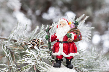 Toy Santa Claus on the fir tree branch