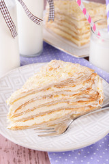 Napoleon cake on plate on table close-up