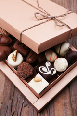 Box filled with chocolates on wooden rustic background