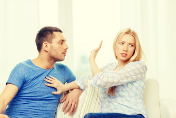 unhappy couple having argument at home