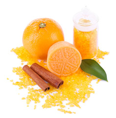 Obraz na płótnie Canvas Bottle of bath salt with fresh orange, bar of soap and cinnamon