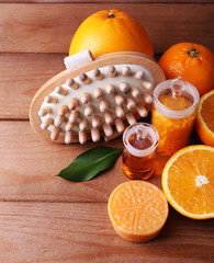 Obraz na płótnie Canvas Ripe orange with bottles of bath salt and essential oil, bar of