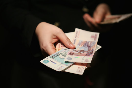 Close-up of a women hands counting Russian banknotes