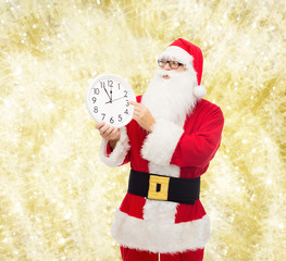 man in costume of santa claus with clock