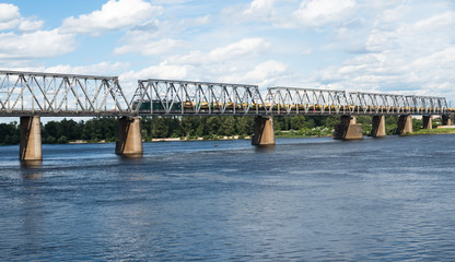 Railroad bridge in Kyiv across the Dnieper with freight train