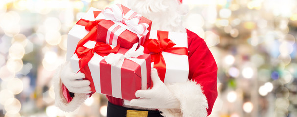 close up of santa claus with gift box