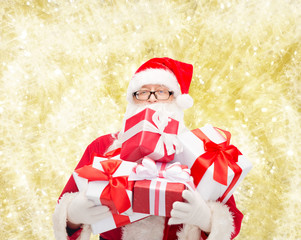 man in costume of santa claus with gift boxes