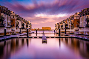 Long exposure at sunset of waterfront condominiums at the Inner