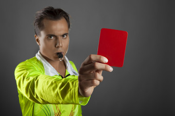 Soccer referee showing the red card isolated on gray background