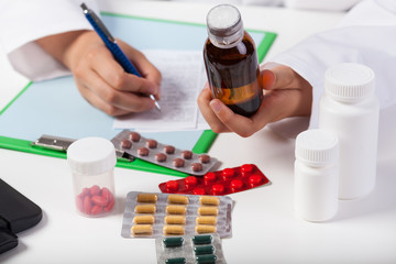 Doctor's hands prescribing syrup