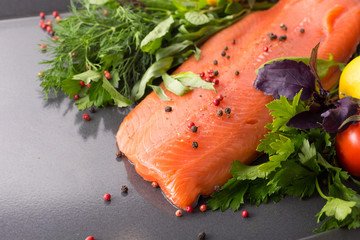 Salmon woth seasoning on a pan