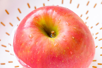 red apple with water drops close up