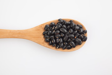 Black beans with wooden spoon