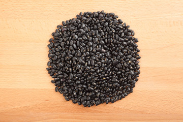 Black beans on wood table