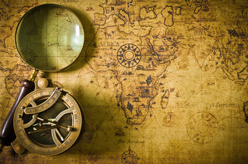 Fototapeta na wymiar old map with compass and Magnifier