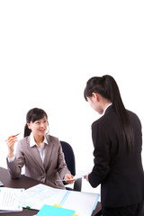 헤드셋을 끼고 책상에서 일하는 두 명의 비즈니스 우먼