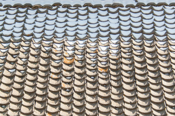 melting snow accumulates on roof tiles