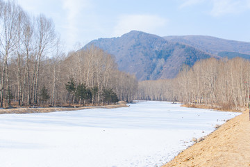 Fototapeta na wymiar frozen river and mountain in northern China