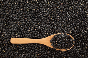 Black beans with wooden spoon