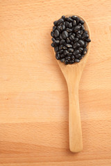 Black beans with wooden spoon