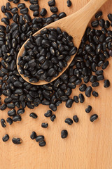 Black beans with wooden spoon