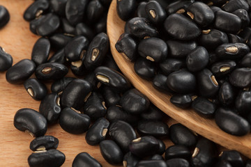 Black beans with wooden spoon