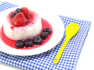 milk pudding dessert with strawberry and blue berry