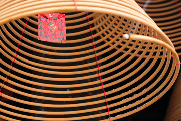 burning chinese circular joss sticks and wish card