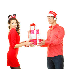 man in santa hat gives a lot of bright gifts for Santa girl