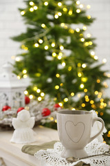 Mug with hot drink and Christmas decorations