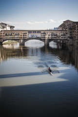 Rowing under Ponte Vecchio in Florence, Tuscany