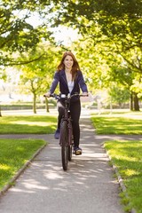 Pretty redhead cycling a bike © WavebreakmediaMicro
