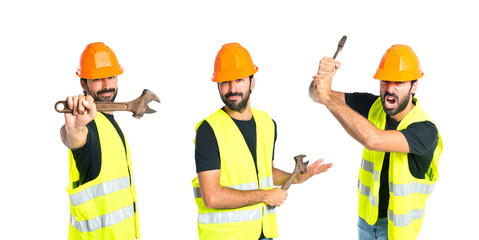 workman with wrench over white background
