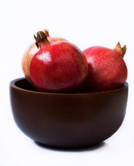Closeup of pomegranates in wooden bowl
