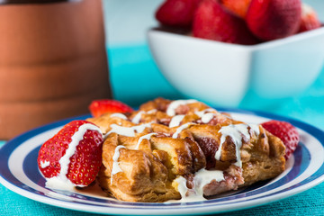 close view on fresh baked croissant with cream and fruits