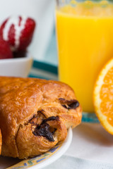 Chocolate croissant with orange juice