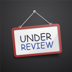 under review hanging sign