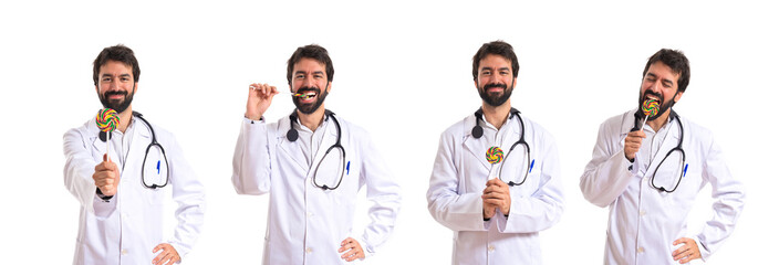 Doctor with lolly pop over white background