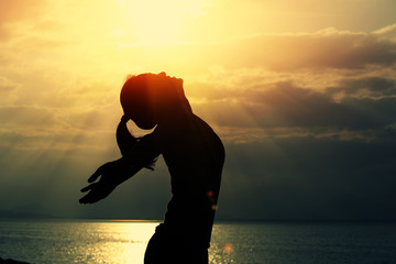 cheering woman hiker open arms at sunrise seaside 