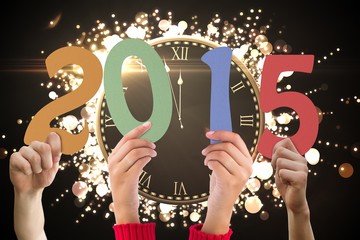 Composite image of hands holding poster