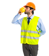 Workman holding a cup of coffee
