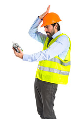 Worker holding vintage clock