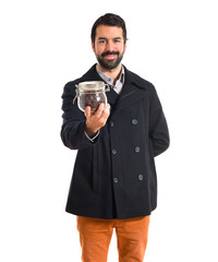 Man holding a jar glass with coffee inside