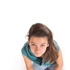 Girl sitting in the floor over white background