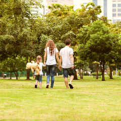 Family walk in the park, happy at sunset in Bangkok, Thailand.