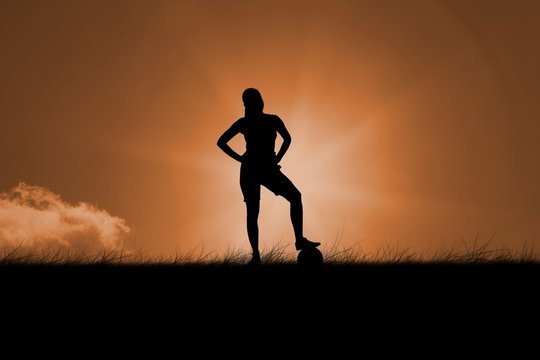 Composite image of fit brunette standing with ball