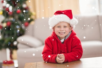 Composite image of festive little boy smiling at camera