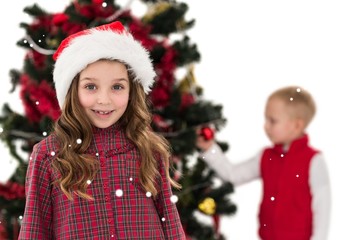 Festive little girl smiling at camera with boy behind