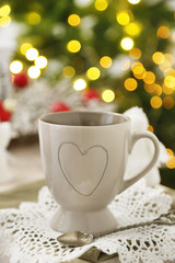 Mug with hot drink and Christmas decorations
